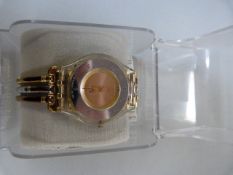 Ladies gold and silver coloured Swatch watch in case