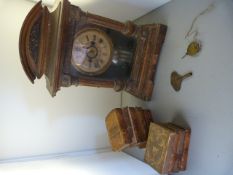 A pillar fronted clock with brass finials and a quantity of vintage books key and (pendulum in