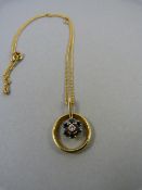 An 18ct gold pendant set with single Diamond and six Sapphires on an 18ct gold chain