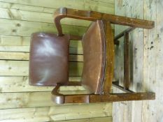 An oak framed captains chair with leather seat