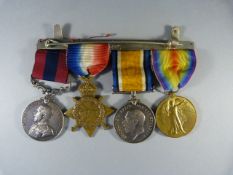 A group of four George V First World War medals comprising, Distinguished Service Medal, 1914-15