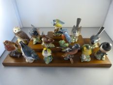 A small quantity of Beswick english birds with a wooden stand