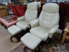 Pair of cream leather reclining swivel chairs with matching footstools