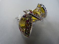 An 18 ct white gold ring set with a large yellow stone ( possibly Citrine) and surrounded by a