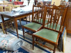 A dining room table and 4 chairs with glass top