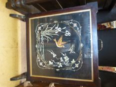 An oak framed fire screen with silk work panel embroidered with birds butterflies and flowers