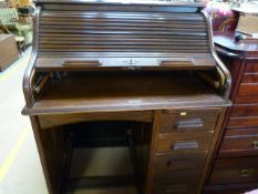 An oak roll top desk