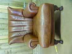 A brown Leather armchair on claw and ball feet