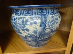 A blue and white Chinese fishbowl, decorated with mandarin ducks, lotus flowers etc.