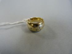 A gentleman's 14 carat gold ring with six small inset diamonds. Total weight 18.5 gms.