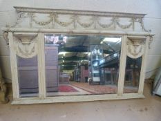 An ornate wooden painted overmantle mirror