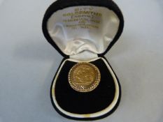 9 Carat ring inset with Half Sovereign marked with Crown & EAD. Total weight 10.9g.