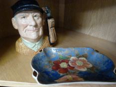 A Royal Doulton 'The Golfer' toby jug and a Royal Doulton flower plate