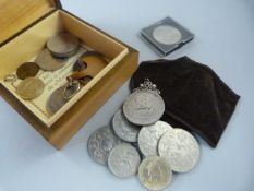 A small quantity of various coins in a box