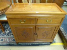 A Chinese dining room suite - compromising of sideboard with two drawers and a circular extending
