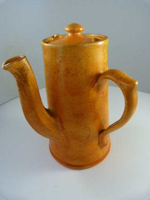 Lidded Coffee Pot with orange glaze marked Baron Barnstaple
