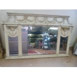 An ornate wooden painted overmantle mirror