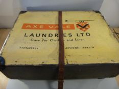A trunk with 'Axe Vale Laundries Ltd' written to front.