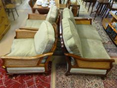 A three piece Bergere suite on mahogany frame with claw and ball feet - compromising of two seater