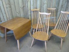 An Ercol table and four chairs - 1 chair with new leg