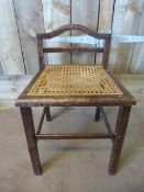 A small cane seated chair