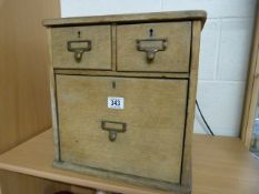 An oak filing drawer of three drawers