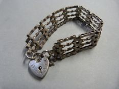A Hallmarked silver gated bracelet joined together by a Padlock heart and safety chain 16 g