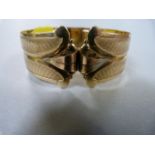 Gold metal bangle hallmarked AMDOUBLE with an anchor and "RW"