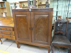 A Mahogany two door cupboard (Key in Office)