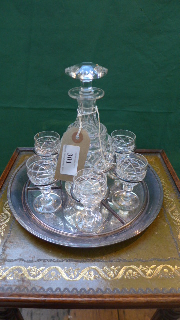 Unusual cut glass liqueur carafe with 6 matching glasses inset plated holder and serving tray