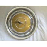 A Mercedes hub cap wall clock.