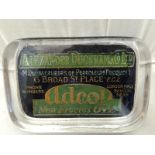 An Alexander Duckham and Co. Limited Adcol glass paperweight with mirrored back.