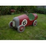 A rare and early tinplate pedal car, possibly Tri-ang in the form of a single seater 1920s racing