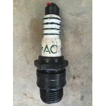 A small AC advertising plastic spark plug, approximately 8" tall.