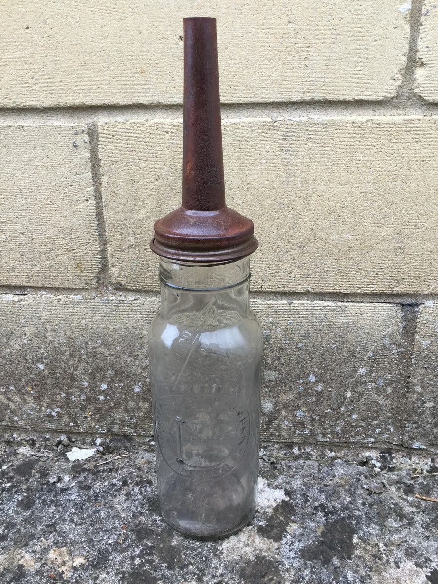 A Standard Oil Company Indiana one liquid quart glass bottle with metal pourer.