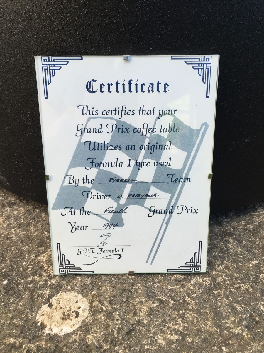 A Tyrrell Formula 1 tyre, forming a table with a glass top and certificate. - Image 2 of 2