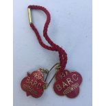 A BARC Goodwood enamel badge for 1957 and matching badge with pin to reverse, both stamped to