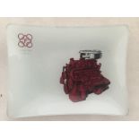 A Perkins Diesel opaque glass trinket dish with pictorial design depicting an engine.