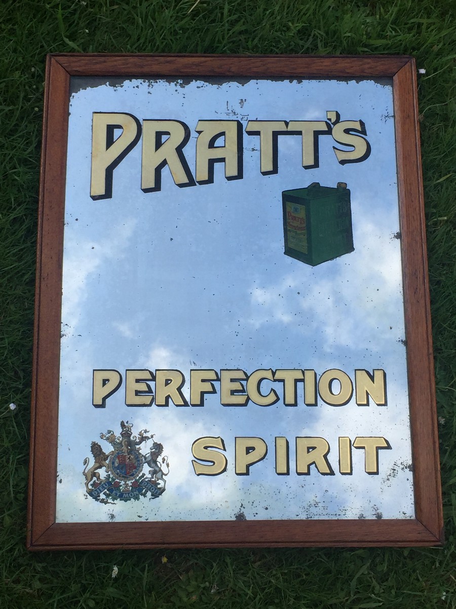 A rare and early Pratt's Perfection Spirit glass advertising mirror with a two gallon petrol can and