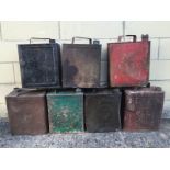 A collection of various petrol cans to include Shell, Esso, W.D 1941 etc.