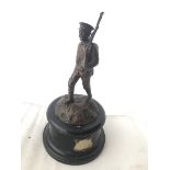 A good quality accessory car mascot in the form of a marching WWI soldier, set on a stylised base,