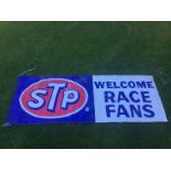 An STP Welcome Race Fans plastic banner, 114 1/2 x 41 1/2" and a smaller STP flag.