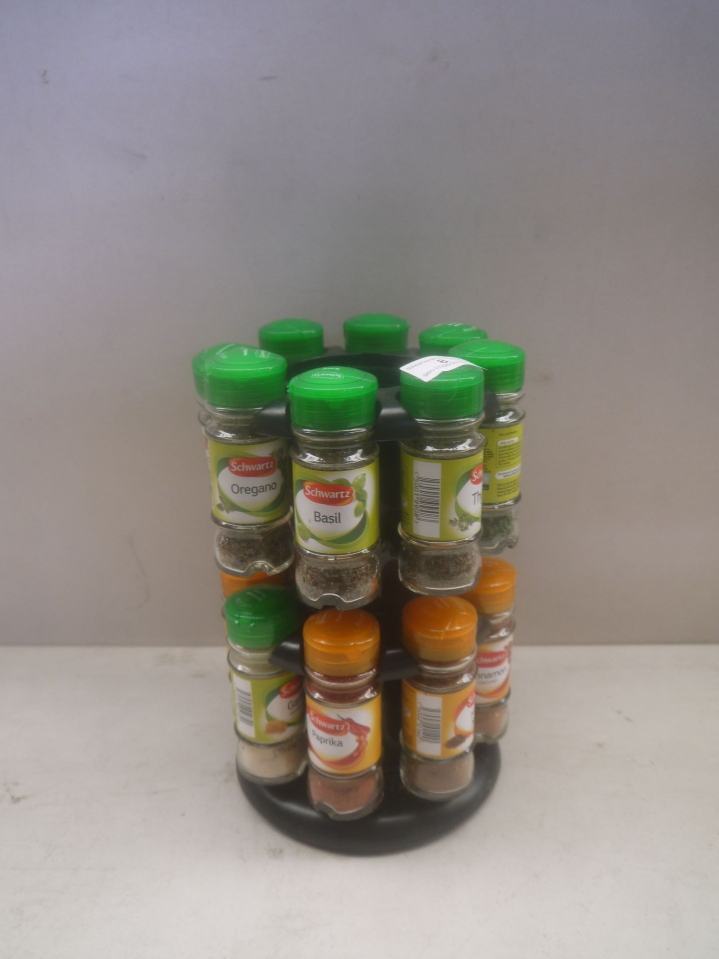 16 Piece Schwartz Spice rack, 2 tier, missing one container.