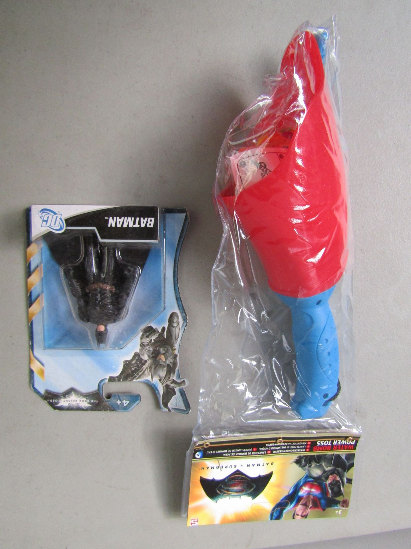 2x Items Being: - 1x Batman Action Figure - 1x Batman Vs Superman Water Bomb Power Toss. Both In