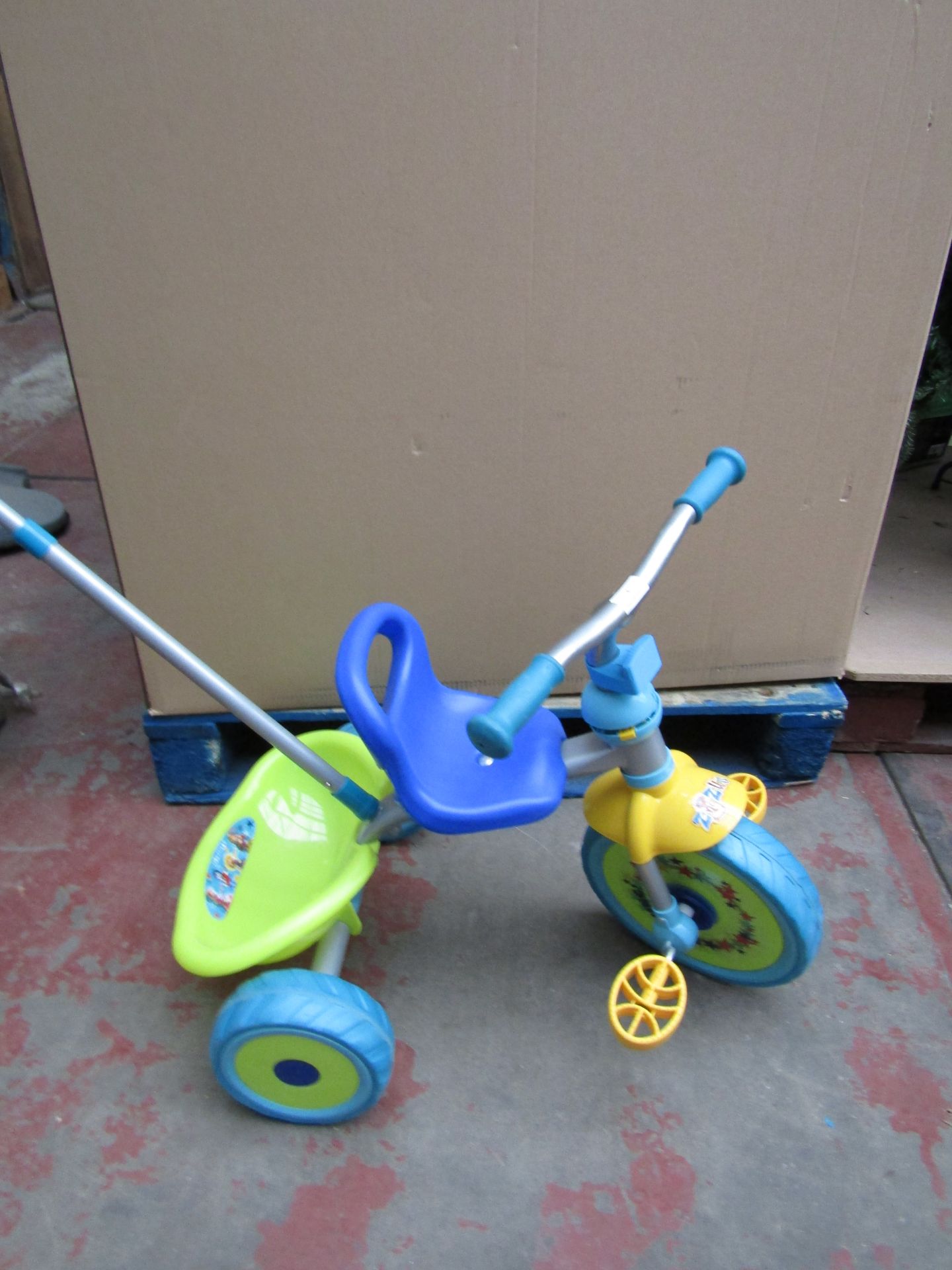 Zingzillas, blue and green colour trike with handle and storage bucket.