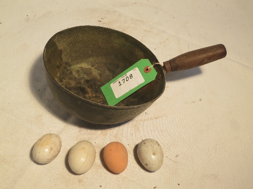 Chicken feed scoop with ceramic and rubber false eggs for broody hens