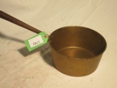 A typical 18thC design of a cast brass saucepan with rolled iron handle