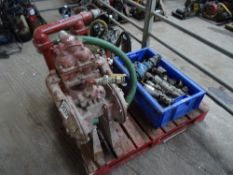 2 red water pumps with tray of fittings