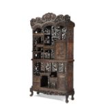 A carved and pierced wood cabinet decorated with dragons and floral motifs, with two doors and