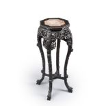 A tall four-legged pierced wood stool, the top made of pink marble (losses and flaws) China, 20th